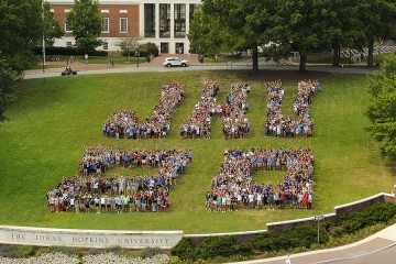 First-year students arrange themselves to spell 'JHU 20'