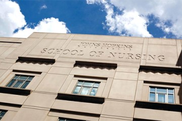 Johns Hopkins School of Nursing exterior with blue sky, clouds in background