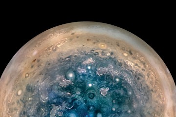 Image depicts the atmosphere of Jupiter with dozens of circular features