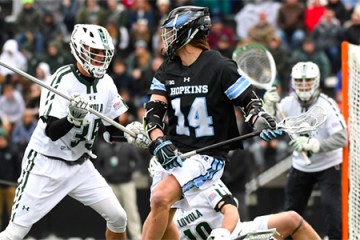 Hopkins lacrosse player heads toward the goal