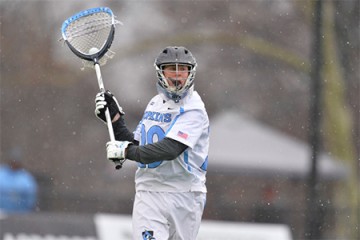 Goalkeeper cradles ball in the snow