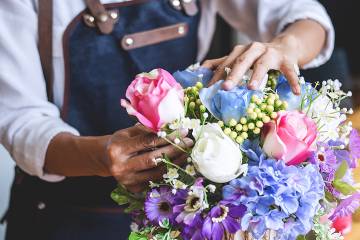 Florist arranging a bouquet of colorful flowers