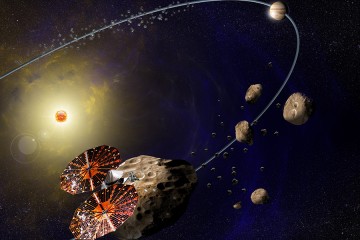 Spacecraft in bottom left corner flies past hunks of rock; in the top right, Jupiter is shown in its orbit around the sun