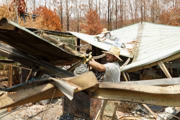 William McNulty sorts through the rubble of a destroyed house