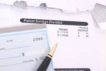 A checkbook and medical bill