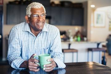 Smiling senior man in his kitchen