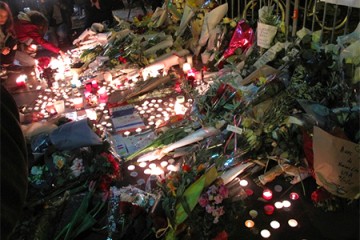 Memorial of candles, flowers, French flags