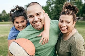 Happy man with wife and young daughter.