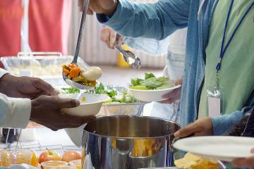Volunteer serving food in a soup kitchen