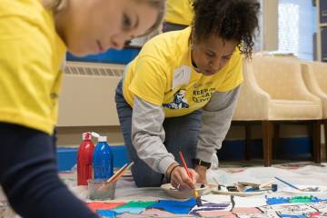 Volunteers painting bannerswill