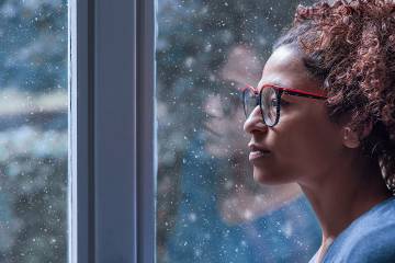 Sad woman looking out a window