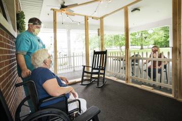 Nursing home resident meets with a family member outdoors