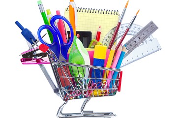 A miniature shopping cart is filled with actual-size office supplies such as pens and scissors.