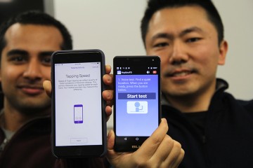 Two men hold up smartphones showing HopkinsPD app