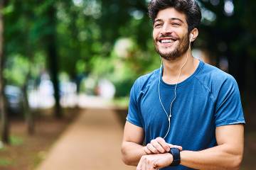 Man checking his fitness tracker outdoors