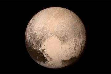 Image depicts Pluto in brown and gray tones