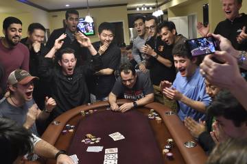 Avi Rubin loses his poker hand as students look on in amazement