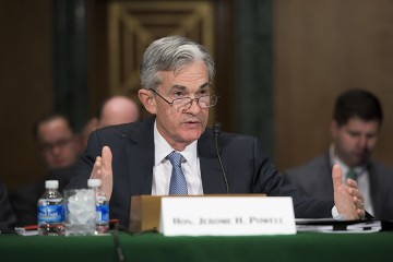 Jerome Powell speaks at a table