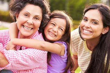 Three generations of women—a grandmother of pre-retirement age with her daughter and young granddaughter