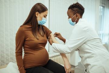 A pregnant woman receives a vaccine