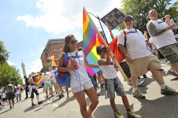 A child carries a rainbow flag in Baltimore's pride parade