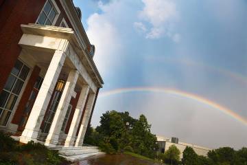 A rainbow appears over Mason Hall