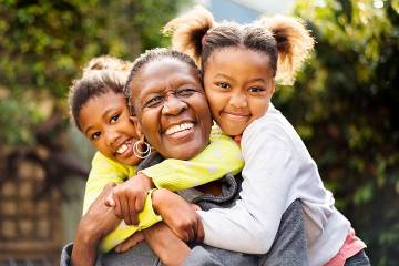 Laughing senior woman with her two granddaughters