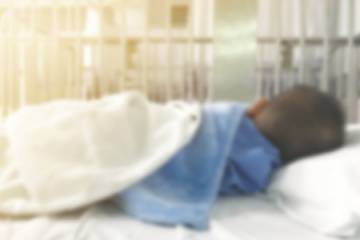 Sick child in hospital bed
