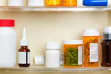 Interior of medicine chest showing prescription drugs and other items