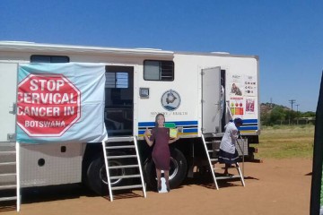 A trailer is labeled with signs reading 'Stop cervical cancer in Botswana'