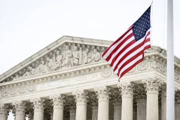 Exterior of the Supreme Court with an American flag flying