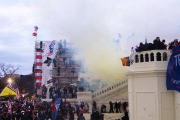 Tear gas engulfs rioters outside the U.S. Capitol building
