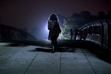 A girl walking into the darkness 