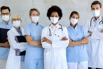 A group of health care providers, all wearing medical protection masks