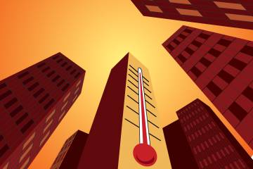 a thermometer runs up the side of a city building