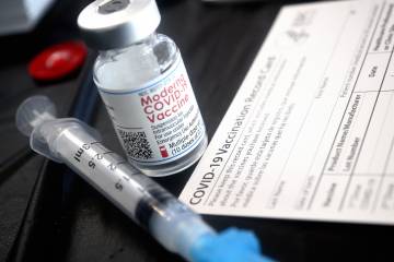 Moderna vaccine vial, vaccine document card, and syringe