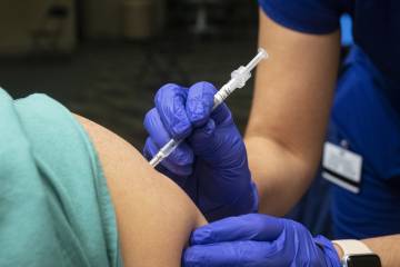 A vaccine is administered in someone's upper arm