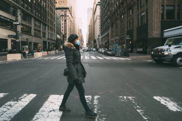 Woman in winter coat crosses street in NYC