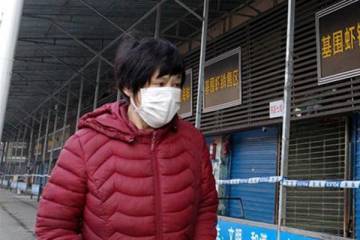 A woman wears a face mask to protect from diseases such as coronavirus