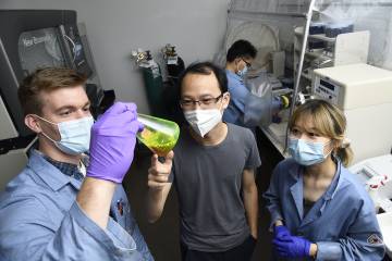 Xiongyi Huang and lab members working on a fluorescent experiment