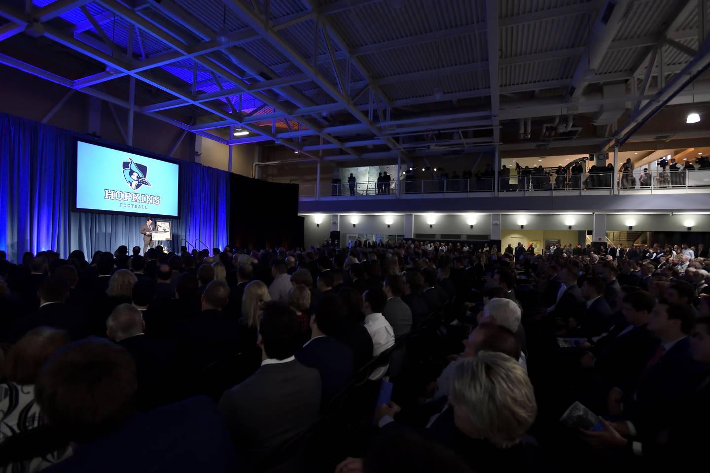 People fill an auditorium for a memorial service