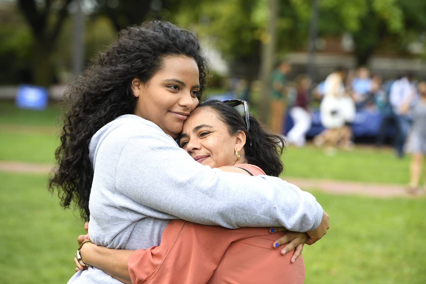 A student hugs her mother