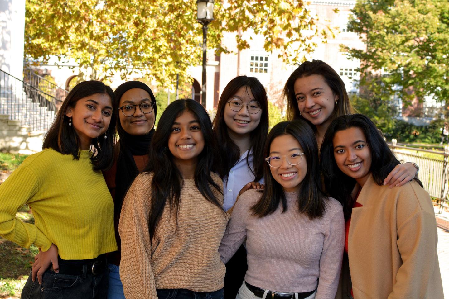 Seven JHU students pose for a photograph