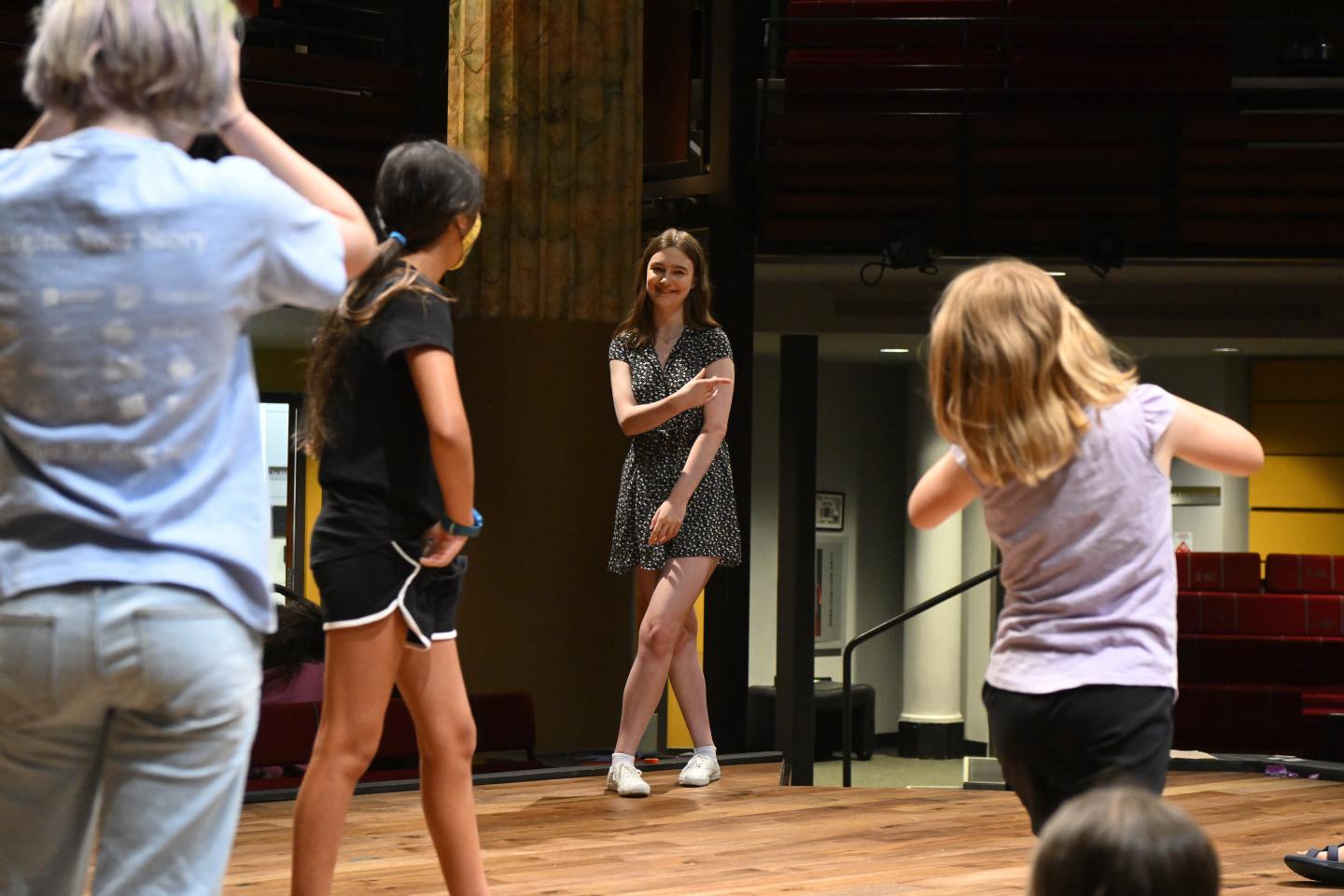 People on stage practicing a play