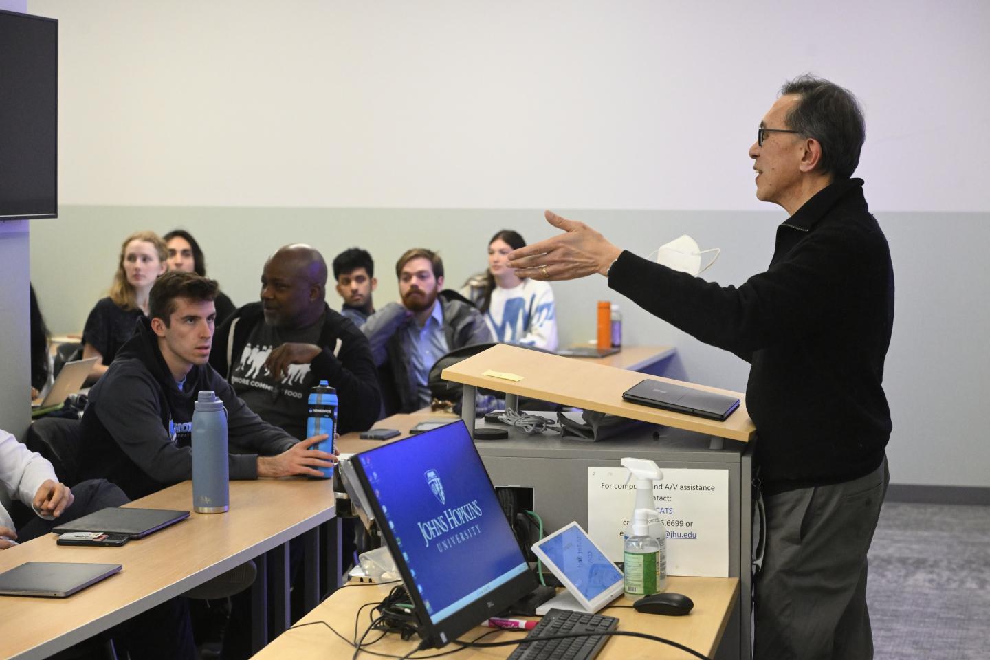 Johns Hopkins professor Fadil Santosa speaks to students in his “Mathematics for a Better World” course.