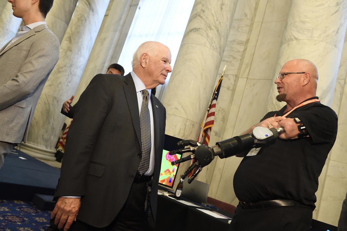 U.S. Sen. Ben Cardin talks with Johnny Matheny, whose prosthetic arm was designed by Johns Hopkins researchers
