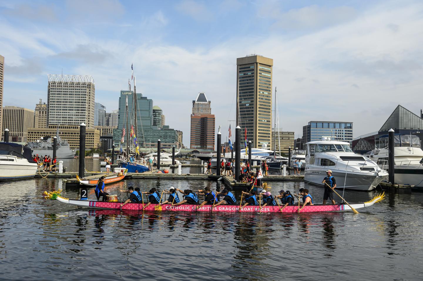 A dragon boat paddles past the docks in Baltimore