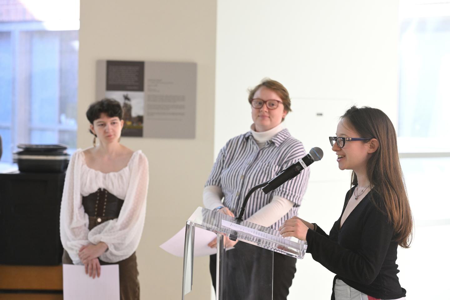 Student speakers Michaella Huertas, Em Ambrosius, and Anna Vakhnovetsky