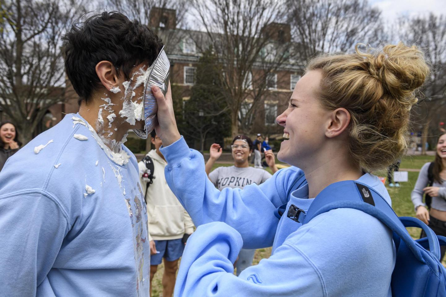 A student pies another student in the face.