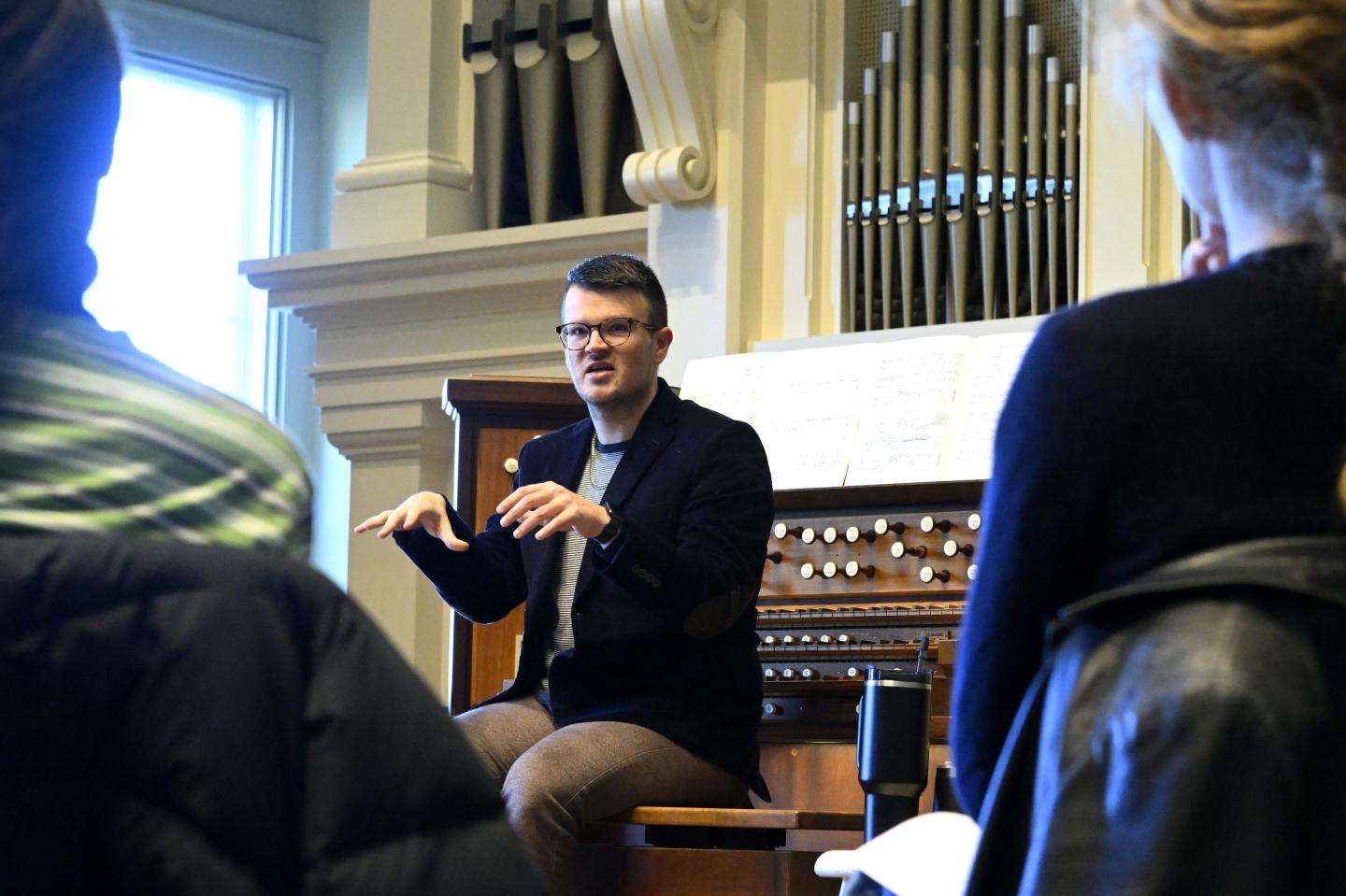 Jordan Prescott leads an Intersession class in front of the organ in Griswold Hall
